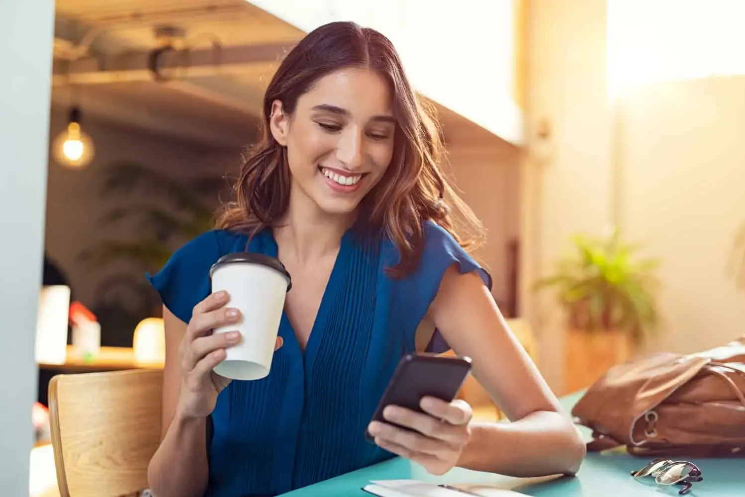 Pet owner smiling at walk updates on her phone