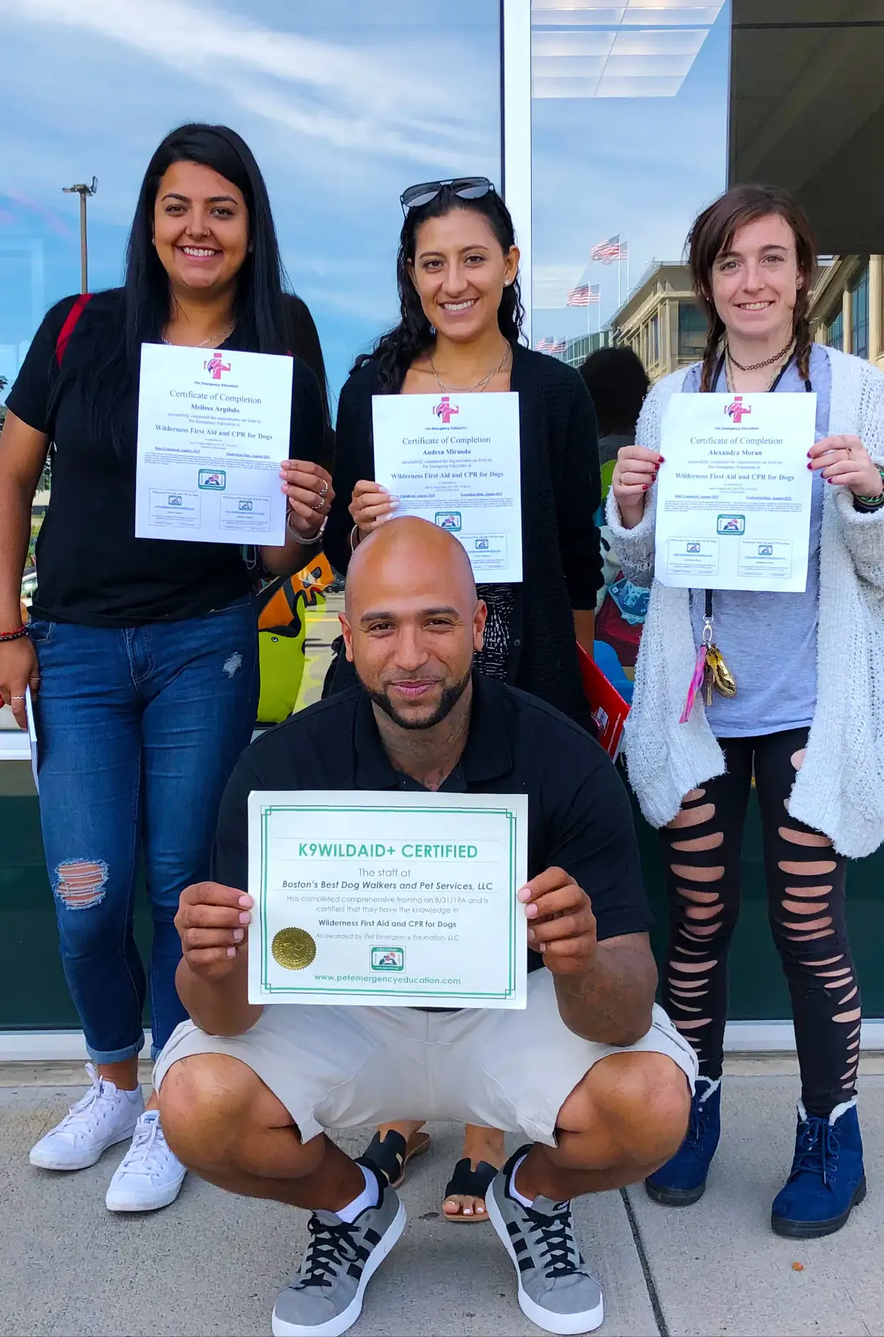 Boston's Best team members holding Wilderness First Aid and CPR for Dogs certificates